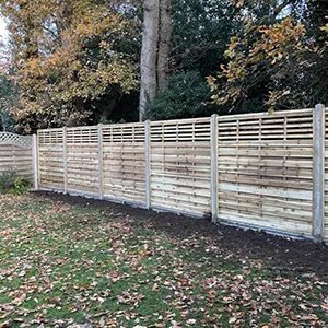 a wooden fence in the middle of a yard