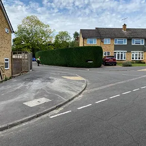 A street with a car parked on the side of it.